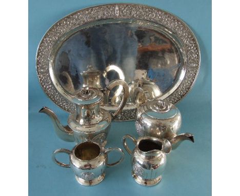A Thai silver four-piece tea and coffee service, with elephant finials and panels of repoussé decoration, together with a sim