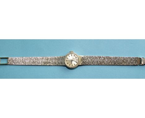Tissot, a 1970's lady's 9ct white gold wrist watch, the circular silvered dial with baton numerals, on integral textured brac