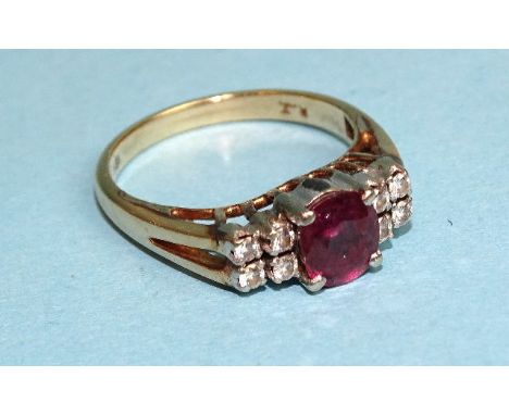 A ruby and diamond ring claw-set a round-cut ruby between two groups of four each brilliant-cut diamonds, in 18ct gold mount,