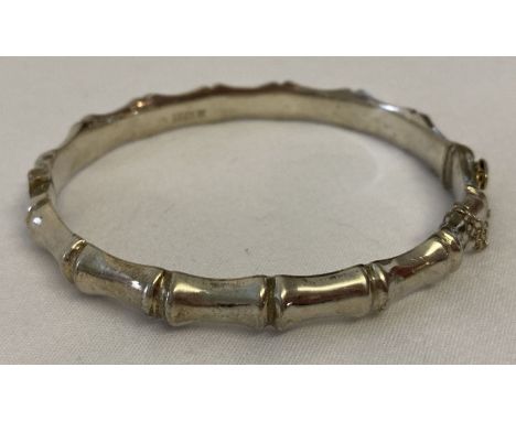 A vintage bamboo design silver bangle with safety chain. Hallmarked Birmingham 1966.  Total weight approx. 10.8g.