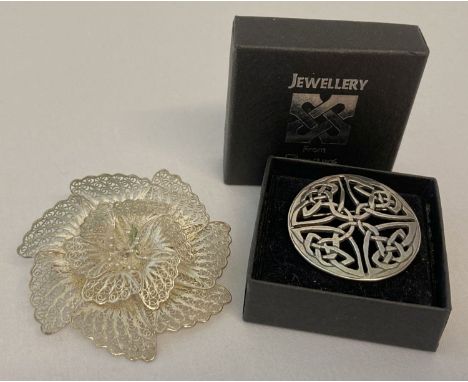 A vintage 925 silver fine filigree flower brooch together with a modern silver Celtic design brooch. Filigree flower stamped 