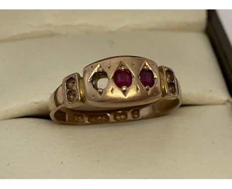 An antique 15ct gold and ruby dress ring, for scrap or repair. Ring set with two central rubies, 5 stones missing. Full hallm