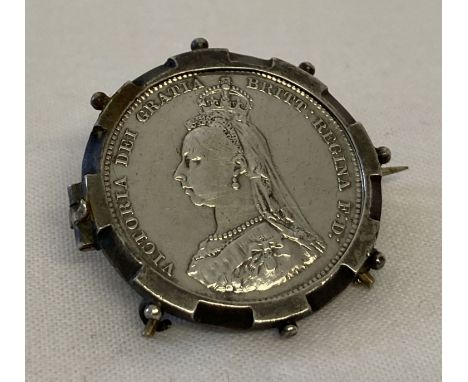 An 1887 Victorian Jubilee head silver shilling, set in a vintage brooch mount.  