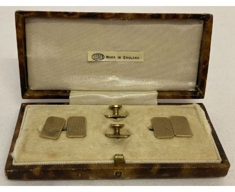 A vintage cased 9ct gold cufflink and collar stud set with engine turned design. Back of cufflinks marked '9ct' and with 'D &