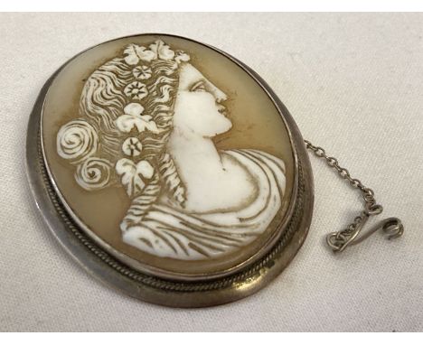 A large vintage white metal cameo brooch with safety chain, pin missing.  Approx 4.6cm x 3.9cm.