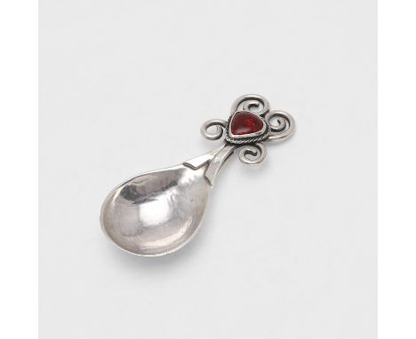with a drop-shaped bowl and a tendril handle set with a red enamel boss, London 1925; 3.5" (9cm) long; 1.25ozt. *Condition: P
