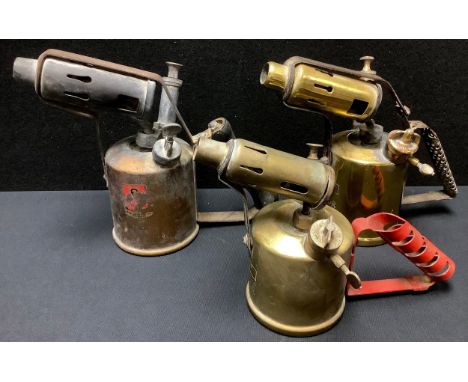 A brass Monitor paraffin blow lamp; two other similar blow torches (3) 