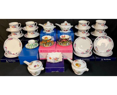 Two Royal Albert Prairie Lily teacups and saucers;  Royal Doulton Autumns Glory teacups and saucers, boxed;  Royal Worcester 
