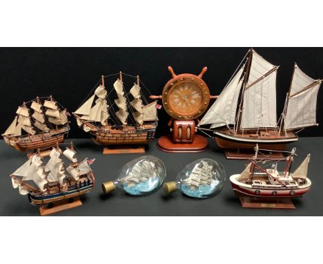 A model ship, HMS Victory, 33cm x 33cm; others, HMS Endeavour, Trawler; a novelty ship's wheel mantel clock, 33cm; two ship's
