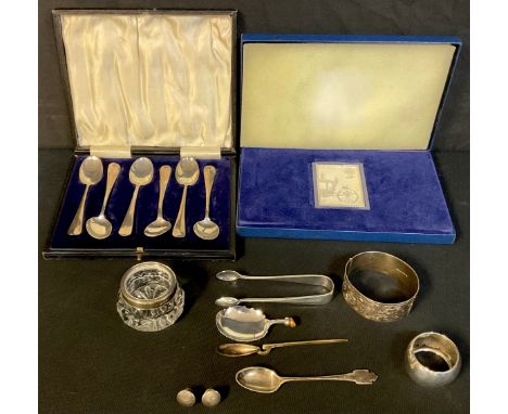 A set of six silver teaspoons, Birmingham 1922/23, 63.6g, cased; a silver 9p stamp ingot, 1978, 75g, cased; a silver Corinium