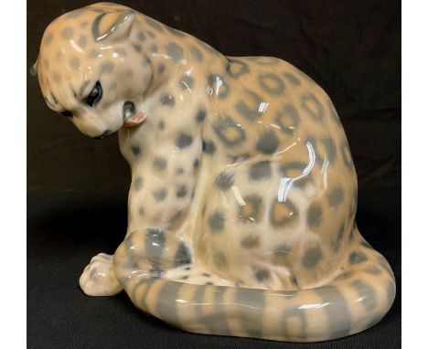 A Royal Copenhagen model of a seated leopard, tail curled, number 2555, 22cm, printed and painted marks 