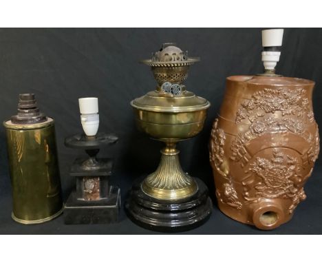 A 19th century salt glazed spirit barrel, later converted to a table lamp; a Victorian brass oil lamp converted to electricit