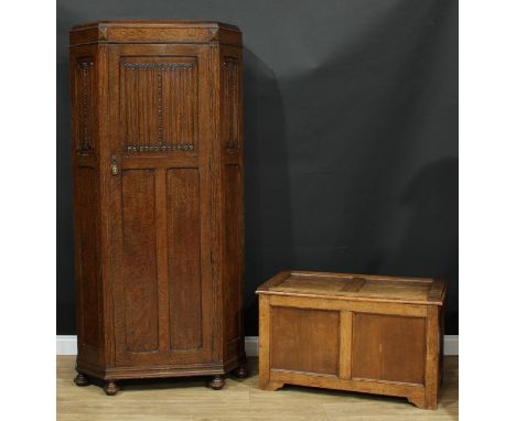 An oak hall robe, rectangular door with linenfold panel enclosing a shelf, hanging rail and a mirror, 193.5cm high, 94.5cm wi