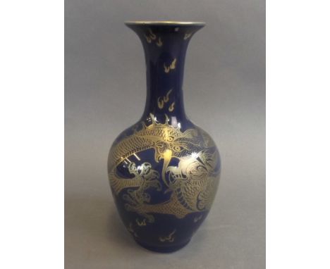 A Chinese royal blue ground porcelain vase with gilt enamel decoration of a dragon chasing the flaming pearl, seal mark to ba