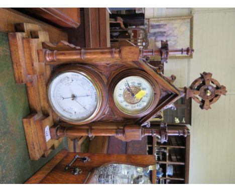 A Victorian oak framed table top compendium of Ecclesiastical form, with time piece, aneroid barometer and curved thermometer