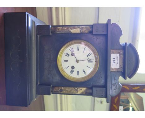A Victorian black slate and marble mantel clock with shaped top and foliate scroll engraving, the enamel dial with twin train