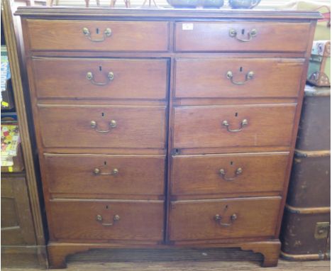 A George III oak cabinet, the two short drawers over a pair of cupboard doors with dummy drawer fronts on bracket feet, 111cm