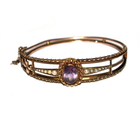 A 9 carat gold bangle, set with centre amethyst and seed pearls