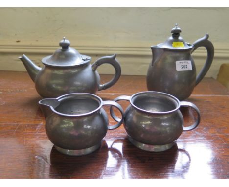 A four piece Liberty & Co hammered pewter tea service, stamped and numbered