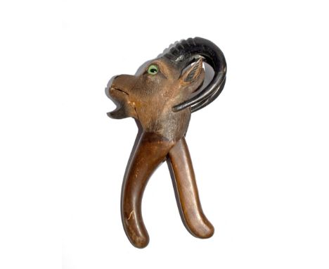 An early 20th century Black Forest nutcracker in the form of a ram's head with original glass eyes