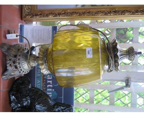 A brass oil lamp of leaf and cabochon design with yellow glass shade, 61cm high