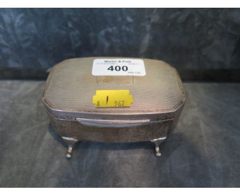 A silver ring box on four feet with engine turned decoration