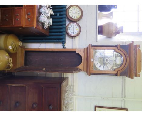 A George III pine longcase clock, the caddy top over a brass dial with gilt metal mask spandrels, silvered dial, seconds dial