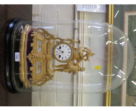A French gilt metal and alabaster mantel clock, the case depicting a walker beckoning a bird over a drum form enamel dial, on