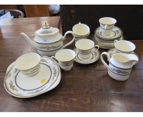 A Minton satinwood pattern tea service with six place settings, milk jug and teapot