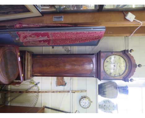 An early 19th century mahogany long case clock, with brass finials, circular painted dial and concave glass over a trunk door