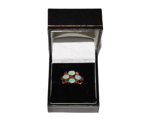 An opal and ruby ring set in 18 carat gold