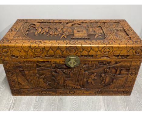 Large Heavily carved trunk with brass fitting - oriental scenes - 105x51cm, height 51cm