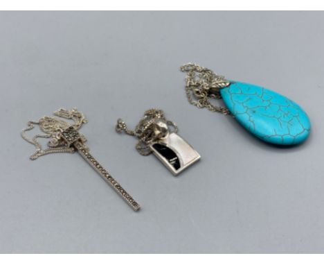 Three silver pendants on silver chains comprising turquoise, marcasite and enamel