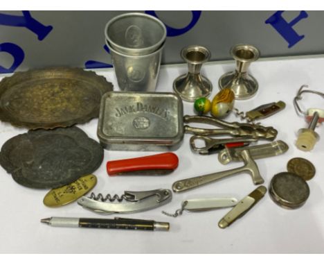 A selection of vintage advertising metal ware, penknives, corkscrews etc
