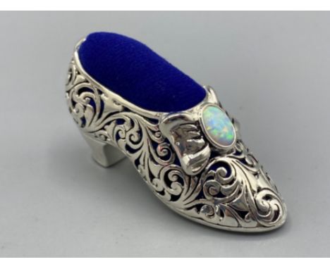 A silver plated pincushion in the form of a shoe with opal cabochon