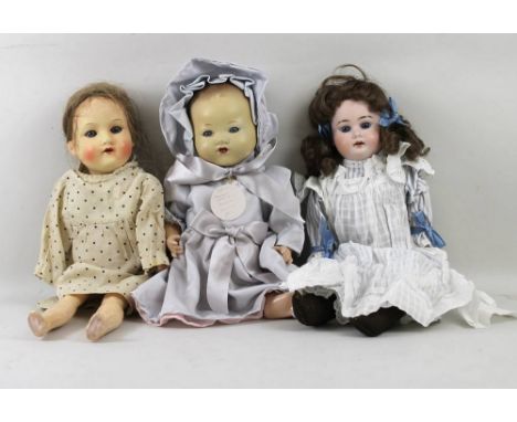 A group of Armand Marseille dolls, one with a bisque head impressed no. 3500 0½ DEP, with sleeping blue eyes, 38cm long, a ba