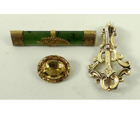 A New Zealand 9ct gold and nephrite jade bar brooch, an oval gold brooch set with a citrine, and a 9ct gold rococo scroll bro