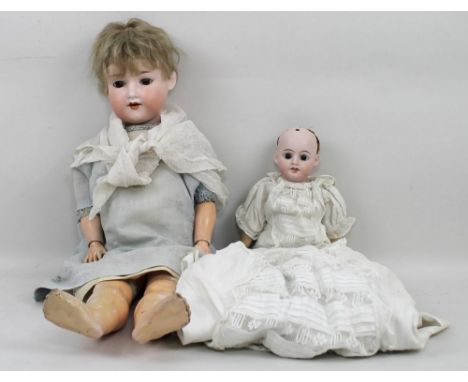 An Armand Marseilles bisque head doll, 390 A6M, 57cm long, and a further doll, marked 'Made in Germany', 33cm long. (2)