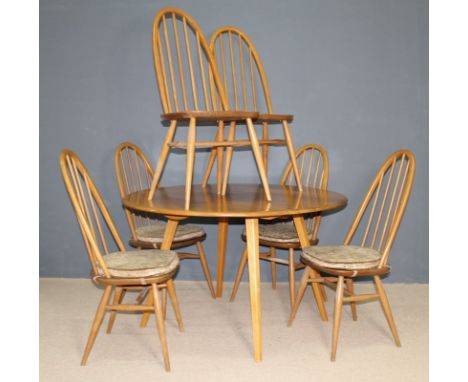 An Ercol ash drop leaf table and six matching stick back chairs, 125 by 113 by 72cm high