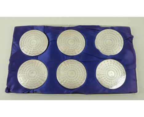 A set of six silver coasters with engine turned decoration, Birmingham 1971, each 7cm, boxed.