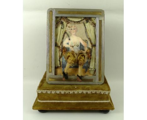 A reproduction musical automaton of a seated courtesan, in a bi colour metal frame and velvet covered base, bears label 'Made