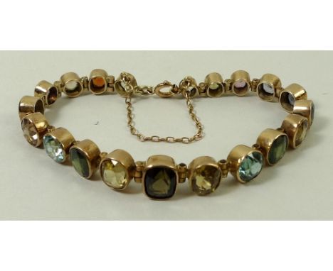 A 9ct gold oval link bracelet set with twenty emerald, oval and brilliant cut semi precious stones, on a bolt ring clasp with