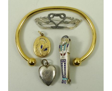 A silver gilt torc bangle, silver and enamel Egyptian Mummy brooch, floral engraved heart shaped locket, scrolling silver bro