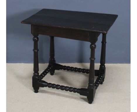 A late 17th century oak occasional table, with turned legs and bobbin turned peripheral stretchers, 73 by 48 by 69cm high. 