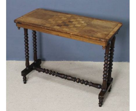 A Victorian mahogany and inlaid rectangular games table raised on bobbin turned supports united by a turned stretcher, 86.5 b