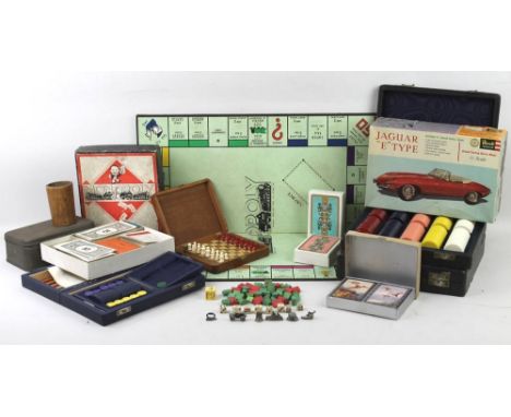 A collection of vintage toys including two sets of gaming chips, Monopoly with wooden houses, backgammon, travel chess, four 