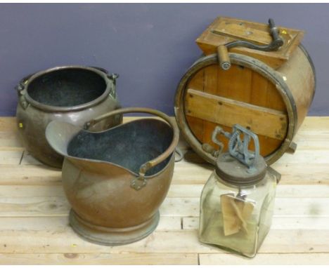 A 19th century wrought iron and copper pot, copper helmet coal scuttle, a Victorian oak butter churn and a 1920's glass bottl