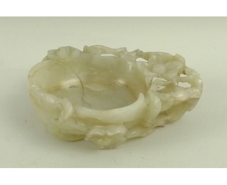 A Qing dynasty jade brush washer carved as a water lily, 8 by 6.5cm.