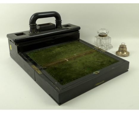 A Victorian ebony writing slop with slide handle and internal drawer, 32 by 25 by 20cm, a glass hexagonal inkwell, and a silv