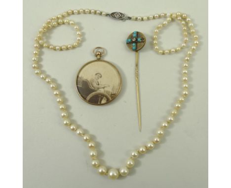 A string of cultured pearls on a 9ct gold clasp, 9ct gold circular photo locket, and a stick pin set with turquoises. (3)